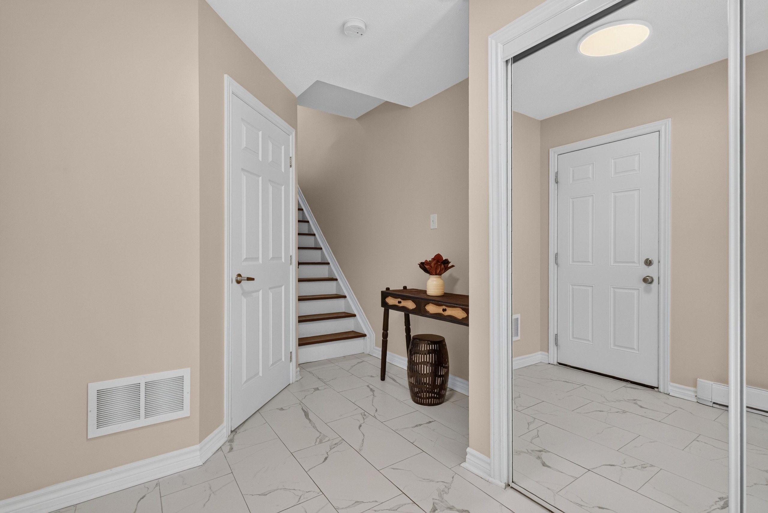 Tiled foyer with staircase